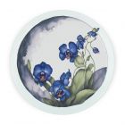 a round glass worktop protector with a purple orchid print